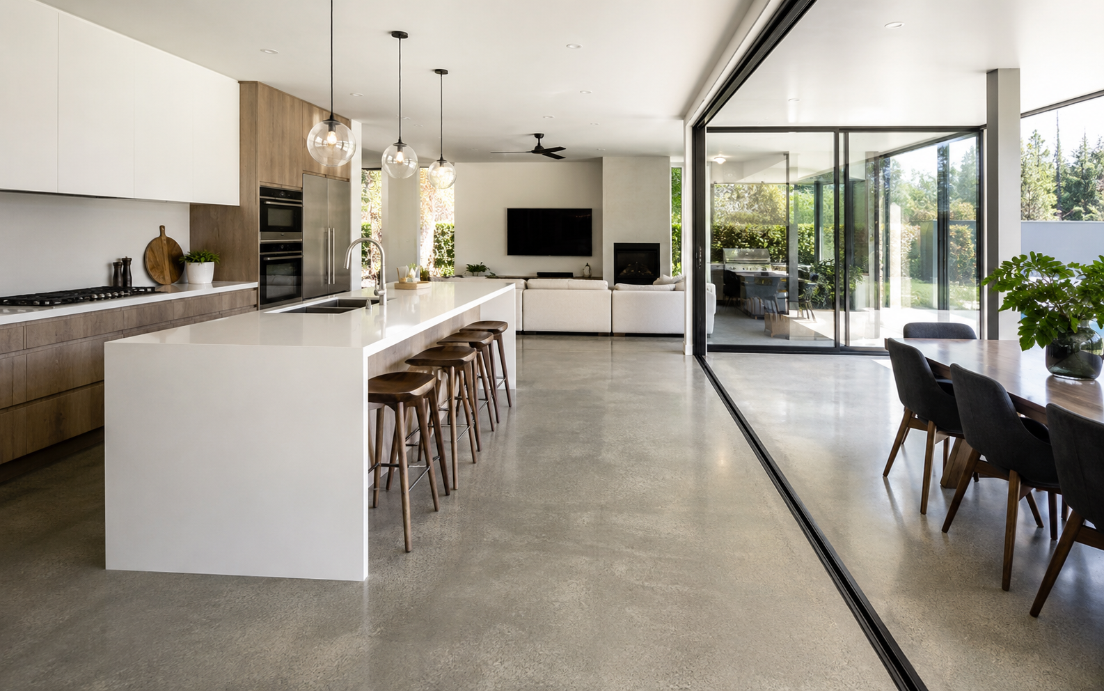 Modern kitchen and dining area with polished concrete flooring